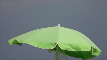 Lime Green Parasol In Wind, Lido, Venice, Italy