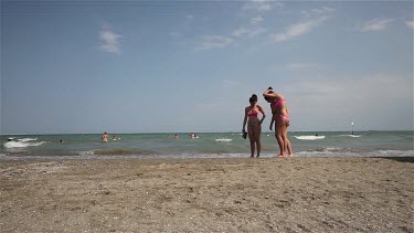 Women In Bikinis Walk On Beach, Lido, Venice, Italy
