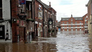 Wheelie Bin And Other Debris Float Down The Street, City Of York, England