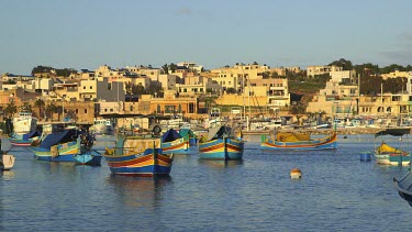 Multi-Coloured Fishing Boat Leaves Harbour, Marsaxlokk, Malta