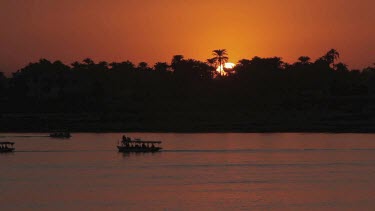 Feluccas & Tourist Boats At Sunset, River Nile, Luxor, Egypt