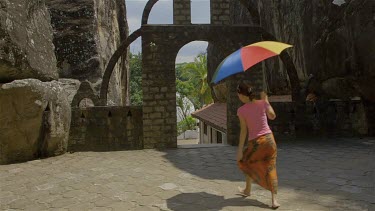 Woman Dancing With Multi-Coloured Umbrella, Aluvihara Rock Cave Temple, Matale, Sri Lanka