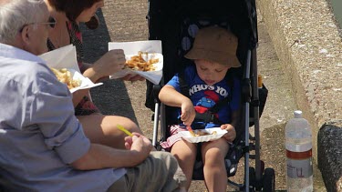 Young Boy Eating Chips From Tray, Bridlington, North Yorkshire, England