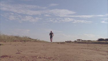 African man running past camera