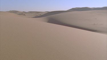 sun glinting on sand dunes late afternoon