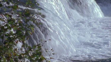 water going over edge of small waterfall rapid