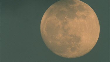 cloud passing in front of full moon till moon is completely covered