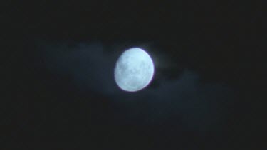 night sky three quarter moon clouds move across