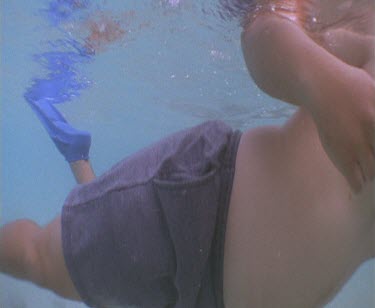 Snorkeller swim over camera.