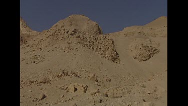 Est shot establishing shot Negev desert scenery. Very rocky stpny desert. No vegetation. Ibex camouflaged.
