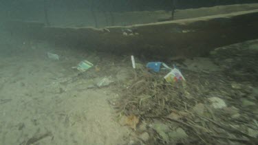 Wrecked sampan and rubbish underwater