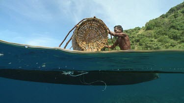 Fish trap on a canoe seen even with the ocean surface