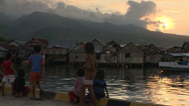 Children in a village at the waterfront