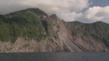Cliffs and falling Komba volcano rocks
