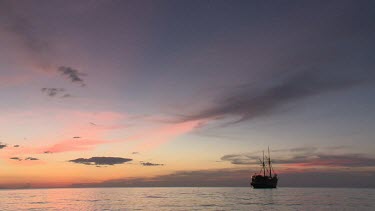 Tender returning to Seven Seas ship at sunset