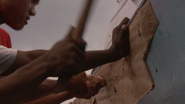 Close up of hands repairing a boat