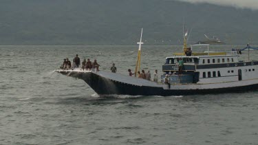 Fishermen trawling on a large fishing boat