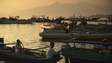 Boats moored in a fishing village at dusk