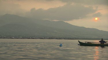 Maumere local in a canoe at sunset