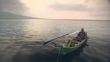 Maumere local in a canoe at sunset