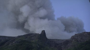 Smoking volcano on the coast