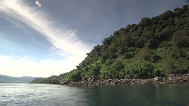 Tender boat speeding past an island