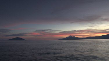 Sunset on the ocean and islands in the distance