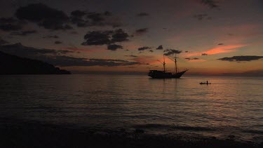 Villager fishing at sunset with Seven Seas ship anchored in the background