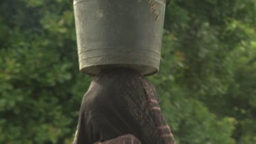 Village girls with buckets on their heads