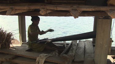 Woman practicing ikat by the sea