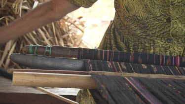 Close up of a woman weaving