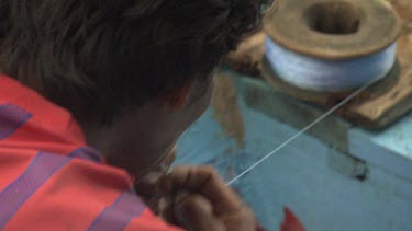 Close up of a fisherman preparing a hook