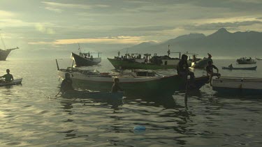 Fishing boats in Maumere harbour seen from a tender boat