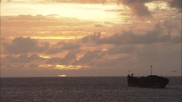 Boat in the water off Heron Island at sunset