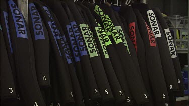 Wetsuits for scuba diving hanging on a rack