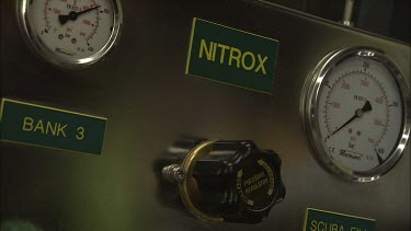 Nitrox fill station panel with a sign beside