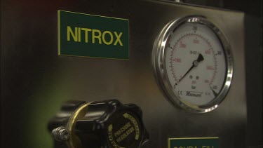 Nitrox fill station panel with a sign beside
