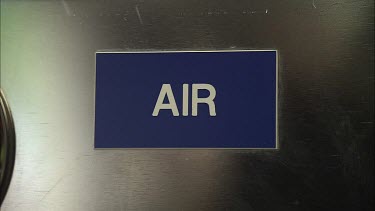 Air fill station panel with a sign beside