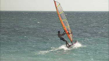 Windsurfing in the sunlit ocean