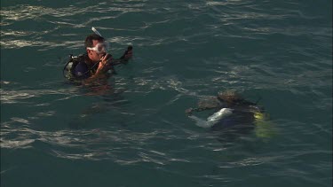 Pair of scuba divers at the ocean surface