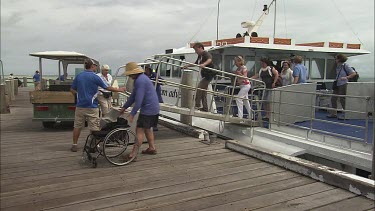 Man sits into a wheel chair