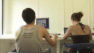 Student researchers working on computers