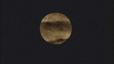 full moon with clouds over