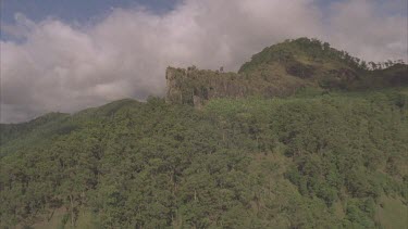 flight over mountains ridge forested towards clouds
