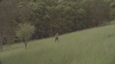 volunteer scientist walking through field