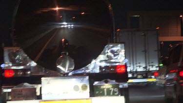 Large trucks driving on a highway at night