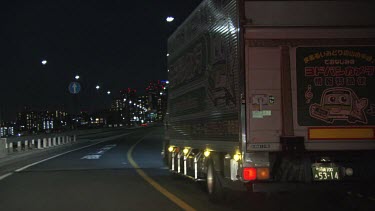 Large truck driving on a highway at night