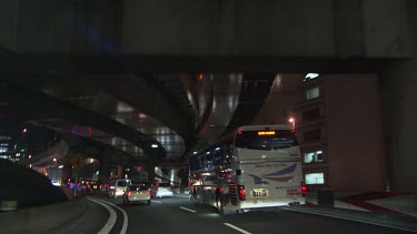 Traffic on a highway underpass at night