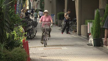People on bicycles cycling on a sidewalk