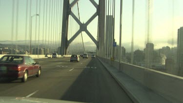 Morning traffic on a bridge into a city
